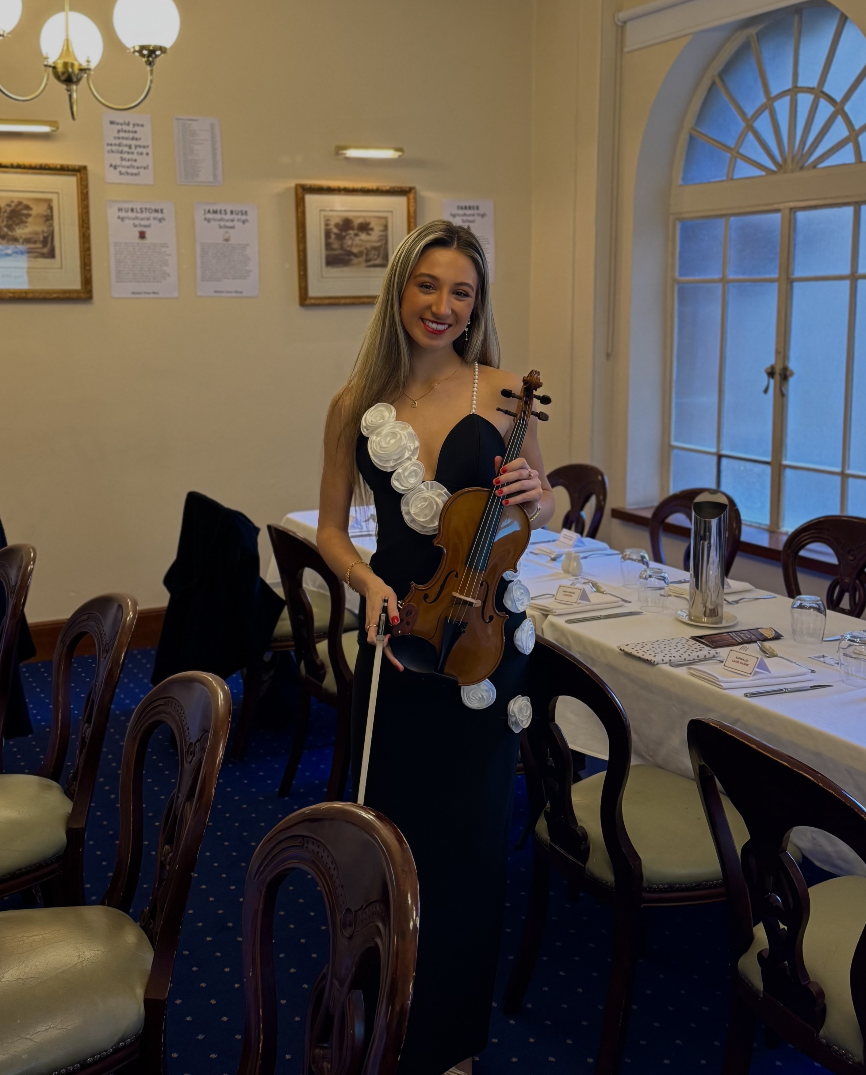 Tali playing violin at park in front of the Sydney Harbour Bridge